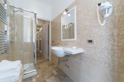 a bathroom with a sink and a shower at Le Chiavi di Roma in Rome