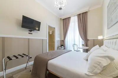a hotel room with a bed and a flat screen tv at Le Chiavi di Roma in Rome
