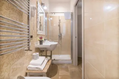 a bathroom with a sink and a toilet and a shower at Le Chiavi di Roma in Rome