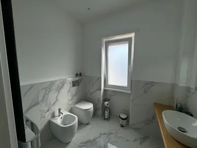 a white bathroom with a sink and a toilet at Alba White in Rome
