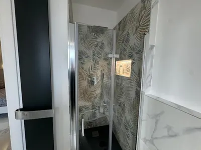 a shower with a glass door in a bathroom at Alba White in Rome