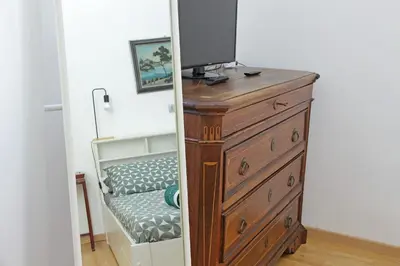 a bedroom with a dresser with a tv on top at Delizioso loft all'Esquilino in Rome