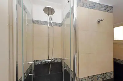a shower with a glass door in a bathroom at Delizioso loft all'Esquilino in Rome
