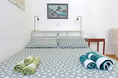 a bedroom with a bed with towels on it at Delizioso loft all'Esquilino in Rome