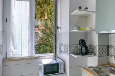 a small kitchen with a microwave and a sink at DOMVS Quattro Venti in Rome