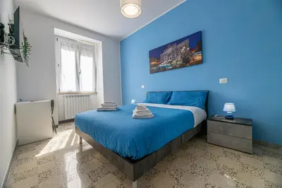 a blue bedroom with a large bed with blue sheets at DOMVS Quattro Venti in Rome