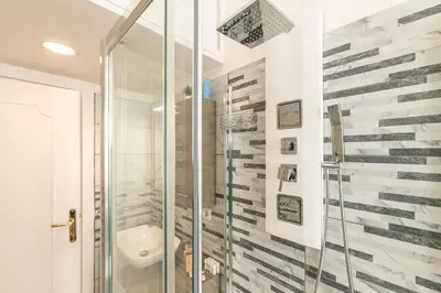a bathroom with a shower and a sink at DOMVS Quattro Venti in Rome