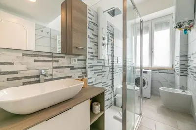 a white bathroom with a sink and a toilet at DOMVS Quattro Venti in Rome