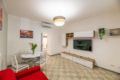 a living room with a red couch and a table at DOMVS Quattro Venti in Rome