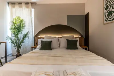 a large bed with a large headboard in a bedroom at Dafne room Ampio nido, vera promessa di relax in Rome