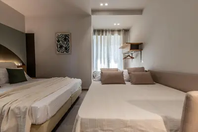 a bedroom with two beds and a window at Dafne room Ampio nido, vera promessa di relax in Rome