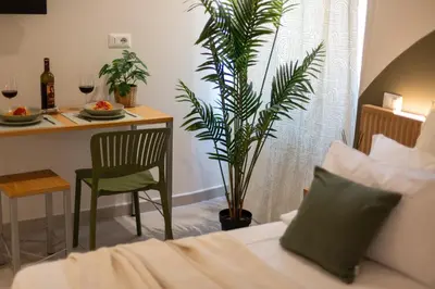 a bedroom with a bed and a table with a plant at Dafne room Ampio nido, vera promessa di relax in Rome
