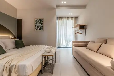 a bedroom with a large bed and a couch at Dafne room Ampio nido, vera promessa di relax in Rome