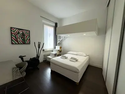 a bedroom with a white bed and a desk at Monti Central in Rome