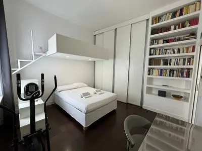 a small bedroom with a bed and a book shelf at Monti Central in Rome