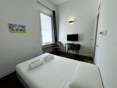 a bedroom with a white bed with two towels on it at Monti Central in Rome