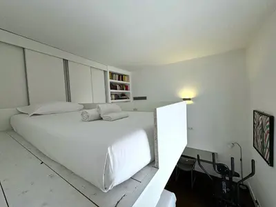 a white bedroom with a large white bed in it at Monti Central in Rome