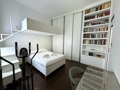 a bedroom with a bed and a book shelf with books at Monti Central in Rome