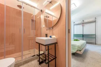 a bathroom with a sink and a mirror and a bed at Heavenly Trevi Luxury Apartment in Rome