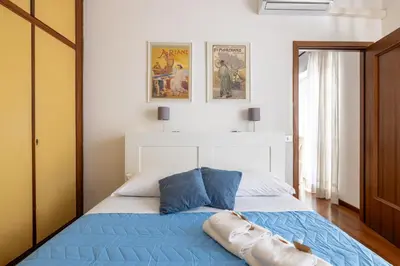 a bedroom with a bed with a blue comforter at Aurelia Dream with Terrace in Rome