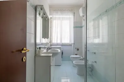 a bathroom with a toilet and a sink and a shower at Aurelia Dream with Terrace in Rome