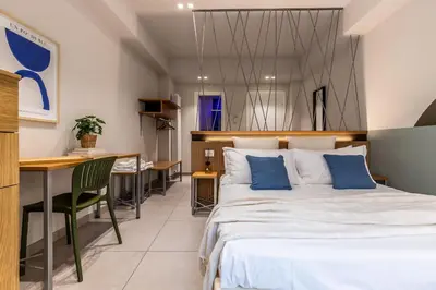 a bedroom with a large bed and a desk at Dafne room Speciale, elegante con balcone in Rome