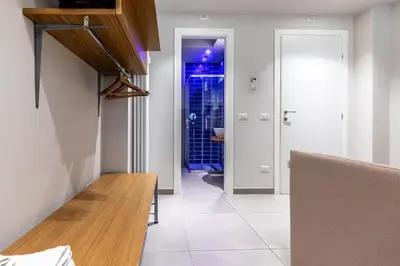 a kitchen with white walls and a wooden counter top at Dafne room Speciale, elegante con balcone in Rome