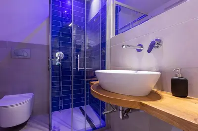 a bathroom with a sink and a glass shower at Dafne room Speciale, elegante con balcone in Rome