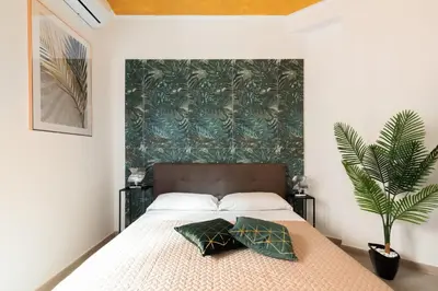 a bedroom with a bed with two pillows on it at Ginny in Trastevere in Rome