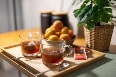 a tray with two cups of tea and a bowl of fruit at Dafne room Un'oasi romana per coppie in Rome