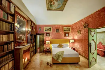 a bedroom with a bed in a room with books at Daplace - Villetta Sant'Onofrio in Rome
