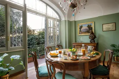 a dining room with a table with food on it at Daplace - Villetta Sant'Onofrio in Rome