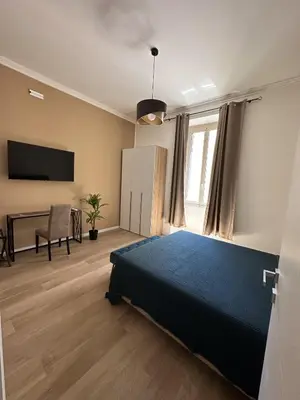 a bedroom with a bed and a desk at Domus Olympia in Rome