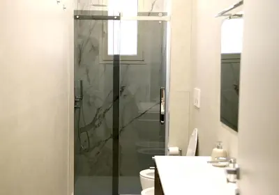 a bathroom with a shower and a toilet and a sink at Domus Olympia in Rome