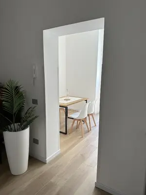 a dining room with a table and a plant at Domus Olympia in Rome