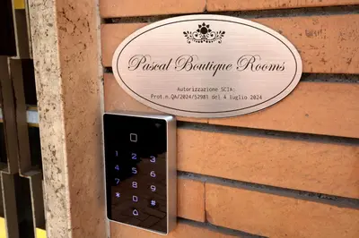 a remote control attached to a building with a sign at Pascal boutique rooms in Rome