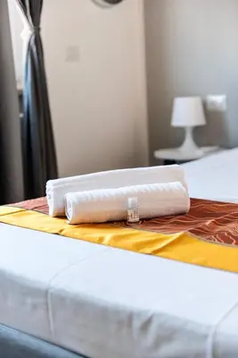 two white towels sitting on top of a bed at Pascal boutique rooms in Rome