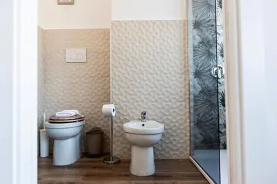 a bathroom with a toilet and a shower at Pascal boutique rooms in Rome