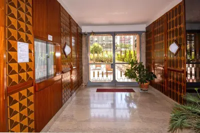 a hallway with wooden walls and a door with windows at Pascal boutique rooms in Rome