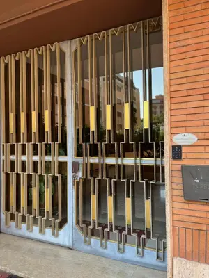 a store front door with a wrought iron gate at Pascal boutique rooms in Rome