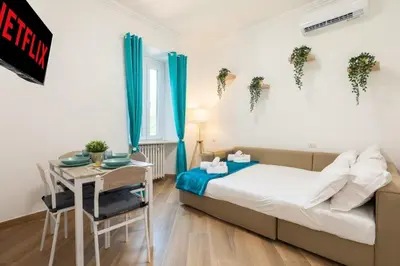 a bedroom with a bed and a desk and a table at Alba Vatican Apartment in Rome