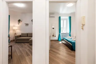 a living room with a bed and a couch at Alba Vatican Apartment in Rome