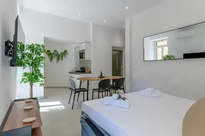 a bedroom with a bed and a table and chairs at Roma apartment near to Colosseum Re-House in Rome