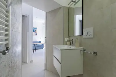 a bathroom with a white sink and a mirror at Roma apartment near to Colosseum Re-House in Rome