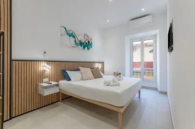 a bedroom with a large white bed and a window at Roma apartment near to Colosseum Re-House in Rome