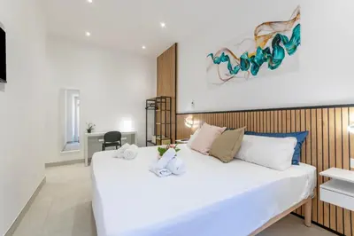 a bedroom with a large white bed in a room at Roma apartment near to Colosseum Re-House in Rome