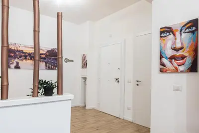 a room with white walls and a painting on the wall at Rea house Colli Albani - B&Brother's rome in Rome