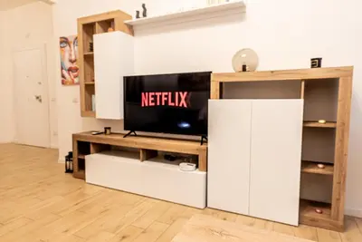 a living room with a television on a tv stand at Rea house Colli Albani - B&Brother's rome in Rome
