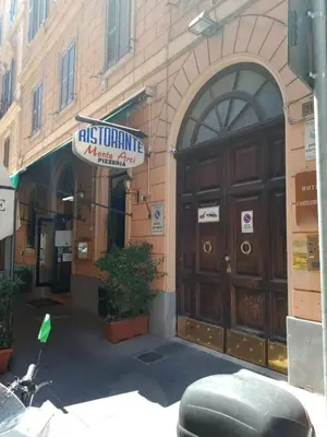 a motorcycle parked in front of a building with a large wooden door at Raynova in Rome