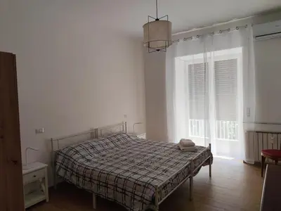 a bedroom with a bed with a blanket and a window at da Giò a Trastevere in Rome